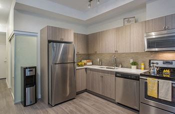 a kitchen with stainless steel appliances and wooden cabinets